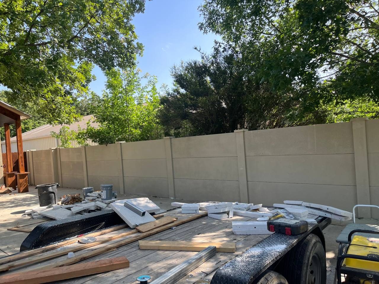 Run of precast concrete privacy fence panels along a property line